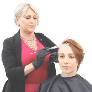 Hairstylist Cherry Pentenbrink coloring clients hair