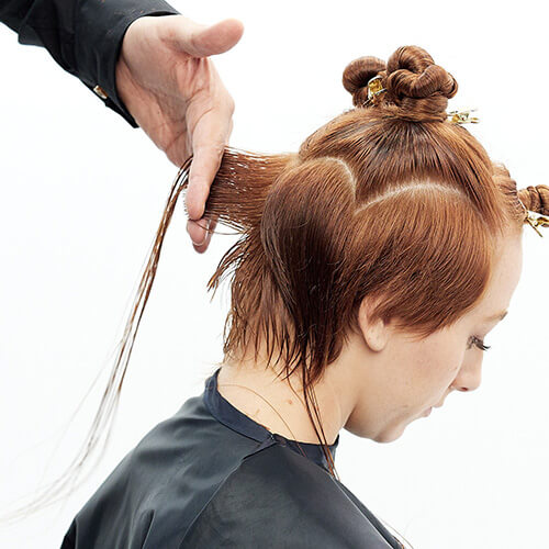 Hairstylist Richard Mannah cutting a bob