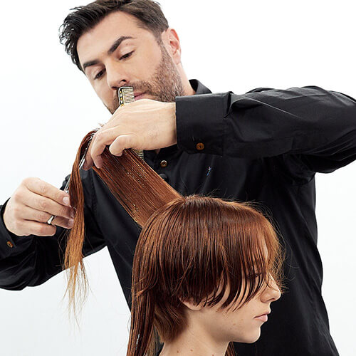 Hairstylist Richard Mannah cutting a bob