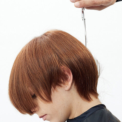 Hairstylist Richard Mannah cutting a bob