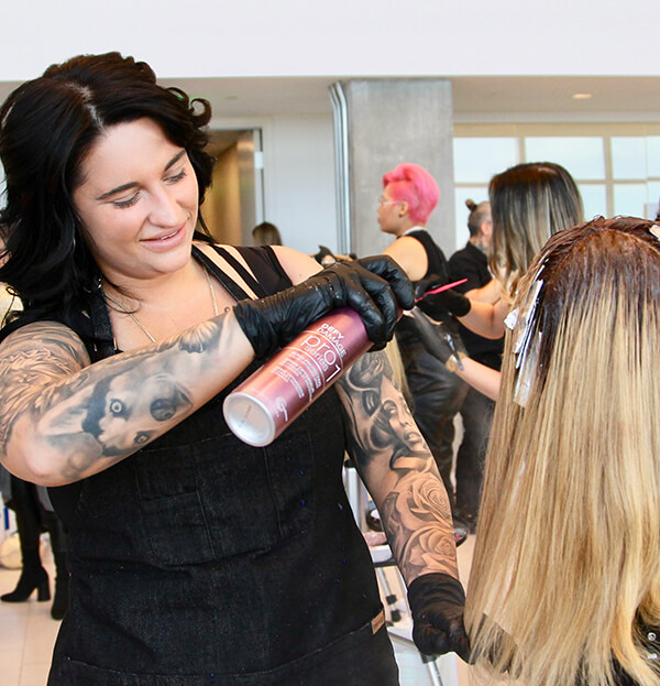 Hairstylist Gina Bianca coloring clients hair