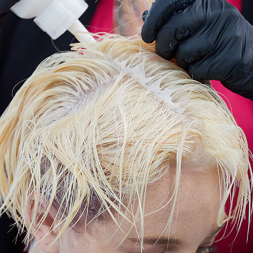 Hairstylist Cherry Pentenbrink coloring clients hair