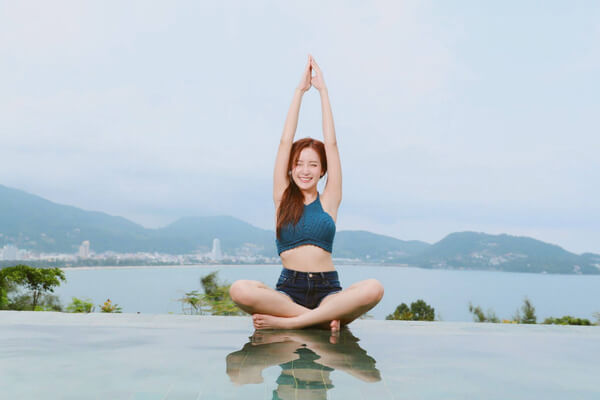 Women doing yoga on beach