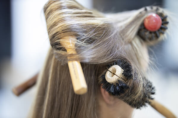 Women with hair brush tangled in hair
