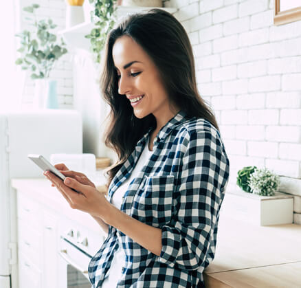 Girl looking at cell phone smiling