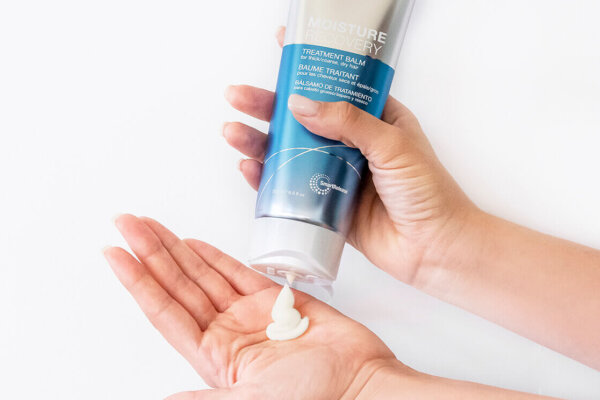 Moisture recovery Treatment Balm bottle squeezing into hand