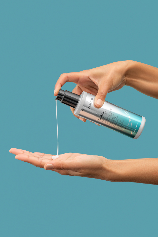 curls like us styler bottle being poured into hand